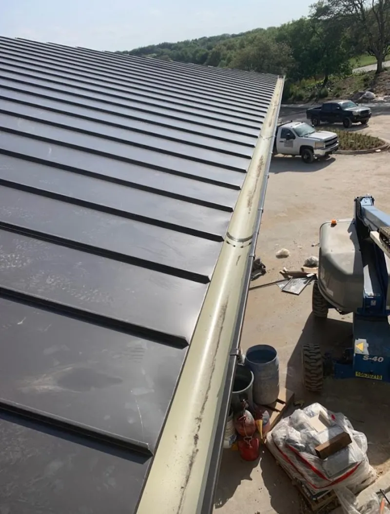 Standing seam panel and gutter detail on a metal roofing jobsite in Brookside